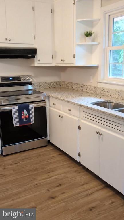 6461 Brokenburg Rd, Spotsylvania, VA 22551 - kitchen with electric range, ventilation hood, white cabinets, and wood finished floors