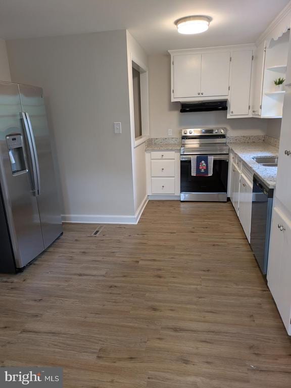 6461 Brokenburg Rd, Spotsylvania, VA 22551 - kitchen with stainless steel appliances, exhaust hood, open shelves, white cabinets, and baseboards