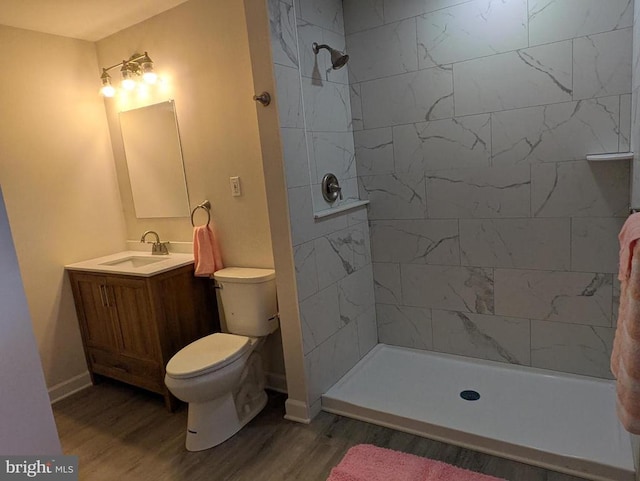 6461 Brokenburg Rd, Spotsylvania, VA 22551 - bathroom featuring toilet, wood finished floors, vanity, tiled shower, and baseboards
