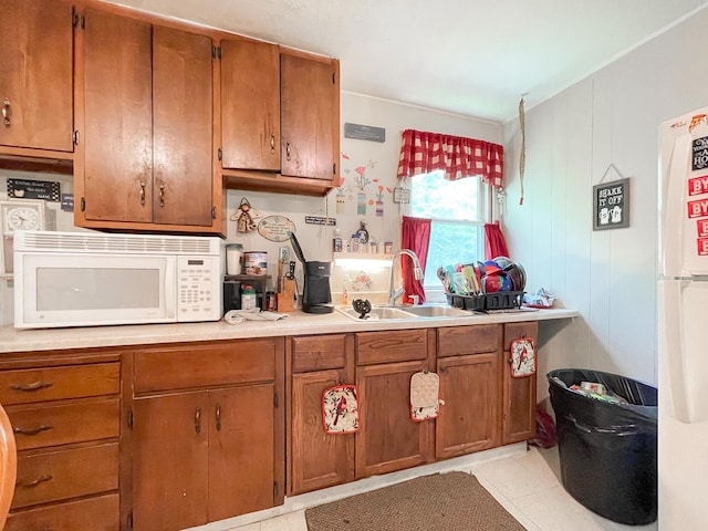 291 Wild Rose Ln, New Market, VA 22844 - kitchen with white appliances, a sink, brown cabinets, and light countertops