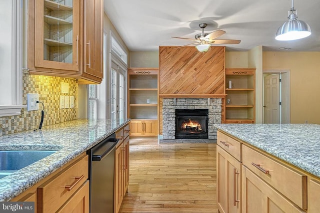 188 Byrd Point Ln, Louisa, VA 23093 - kitchen featuring dishwashing machine, ceiling fan, light stone counters, light wood-type flooring, and tasteful backsplash