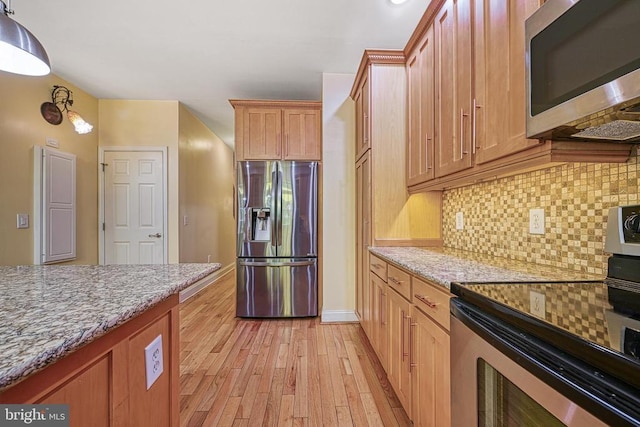 188 Byrd Point Ln, Louisa, VA 23093 - kitchen featuring appliances with stainless steel finishes, light wood-style floors, backsplash, and light stone countertops