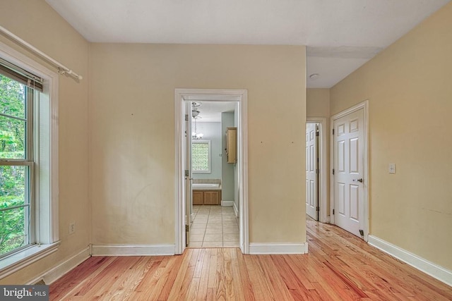 188 Byrd Point Ln, Louisa, VA 23093 - unfurnished bedroom featuring light wood finished floors and connected bathroom