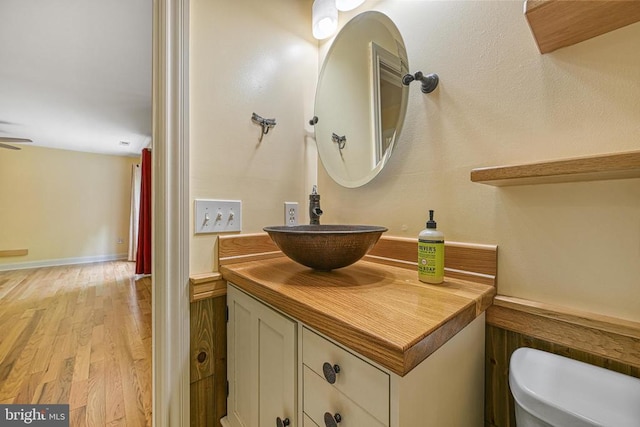 188 Byrd Point Ln, Louisa, VA 23093 - bathroom with vanity, wood finished floors, a wainscoted wall, and ceiling fan