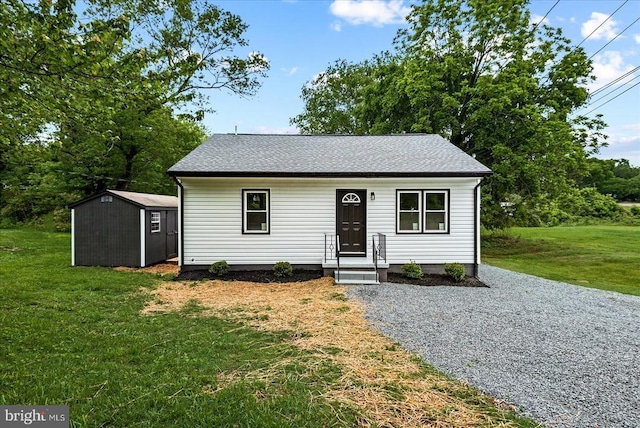 105 Cammack St, Louisa, VA 23093 - view of front facade with a shed, a front yard, an outbuilding, and a shingled roof