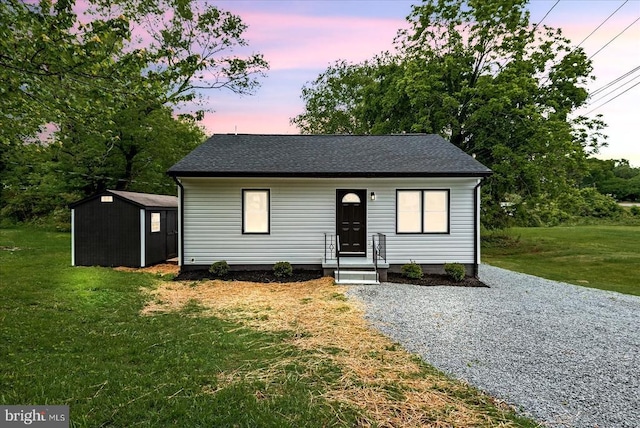 105 Cammack St, Louisa, VA 23093 - view of front of property featuring a storage shed, a front yard, an outdoor structure, and roof with shingles