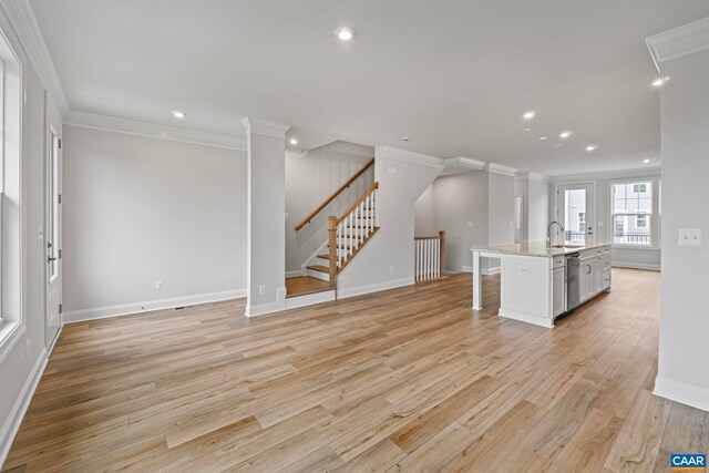 unfurnished living room with crown molding, recessed lighting, baseboards, and light wood-style floors