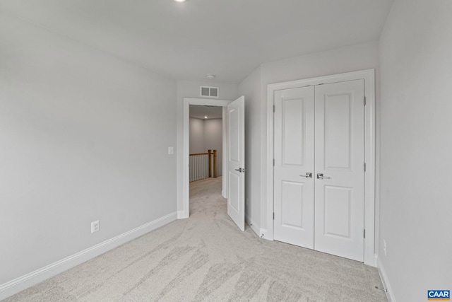 unfurnished bedroom featuring a closet, carpet, visible vents, recessed lighting, and baseboards