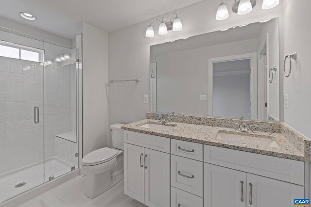 full bath with a sink, double vanity, toilet, and a stall shower