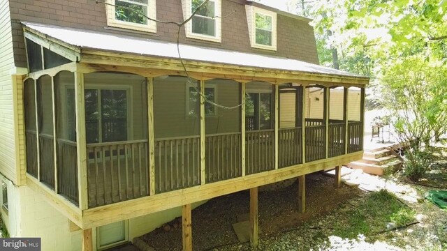  - view of property exterior with a sunroom