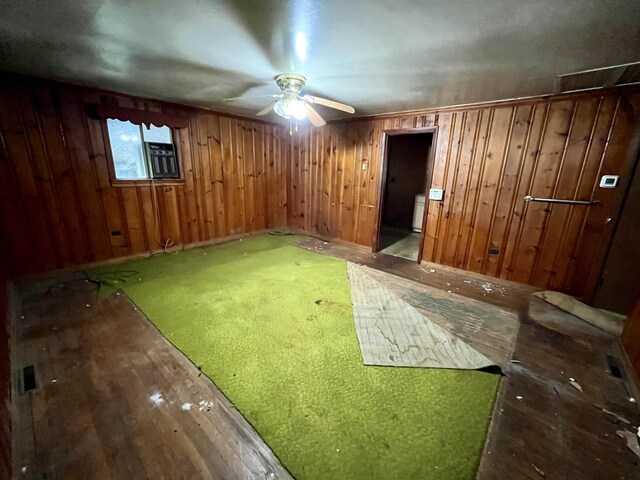 interior space with ceiling fan