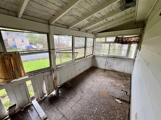 unfurnished sunroom with tile patterned floors and lofted ceiling