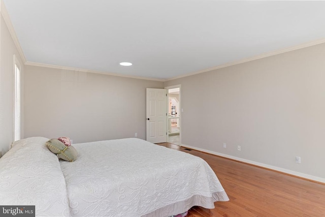 bedroom featuring wood finished floors, baseboards, crown molding, and recessed lighting