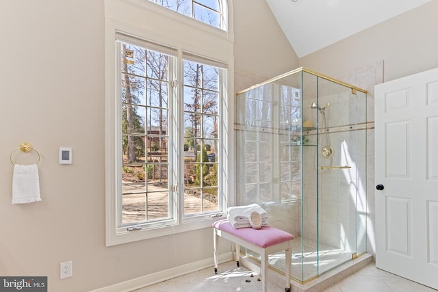 bathroom featuring a shower stall, lofted ceiling, and baseboards