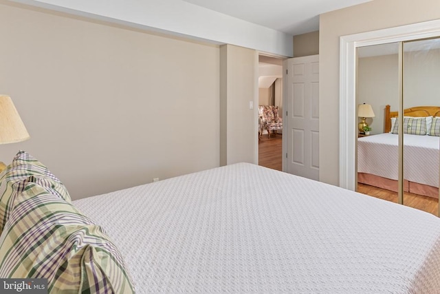 bedroom featuring wood finished floors and a closet
