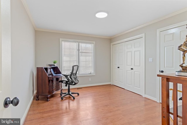 home office with light wood finished floors, ornamental molding, and baseboards