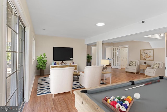 game room featuring wood finished floors, french doors, and baseboards