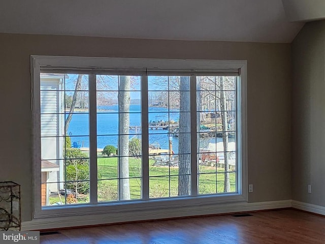 detailed view of a water view, wood finished floors, and baseboards