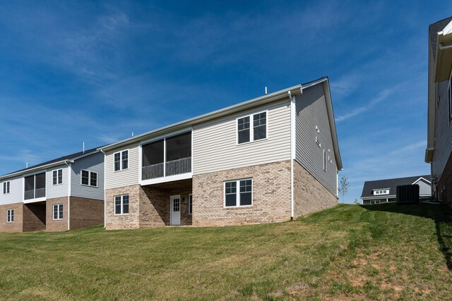 216 Spring Run Ln, Waynesboro, VA 22980 - back of property with brick siding, a lawn, central AC unit, and a sunroom