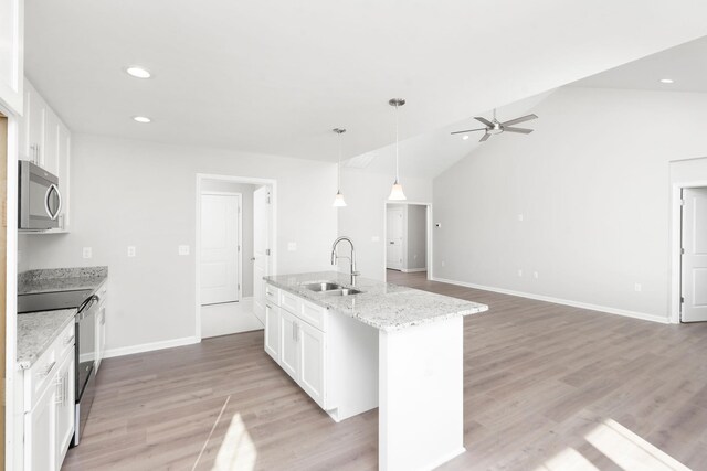 216 Spring Run Ln, Waynesboro, VA 22980 - kitchen featuring stainless steel microwave, electric range oven, a sink, an island with sink, and white cabinetry