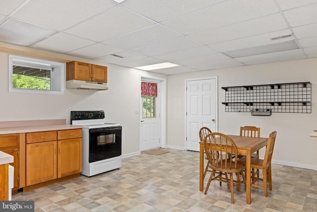 kitchen with range with electric cooktop, a healthy amount of sunlight, a paneled ceiling, and under cabinet range hood