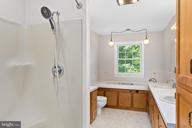 bathroom featuring double vanity, a shower, tile patterned floors, a sink, and a bath