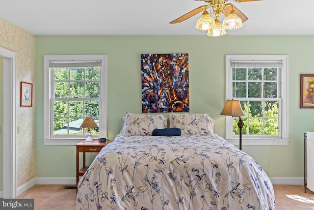 bedroom with light carpet, visible vents, and baseboards