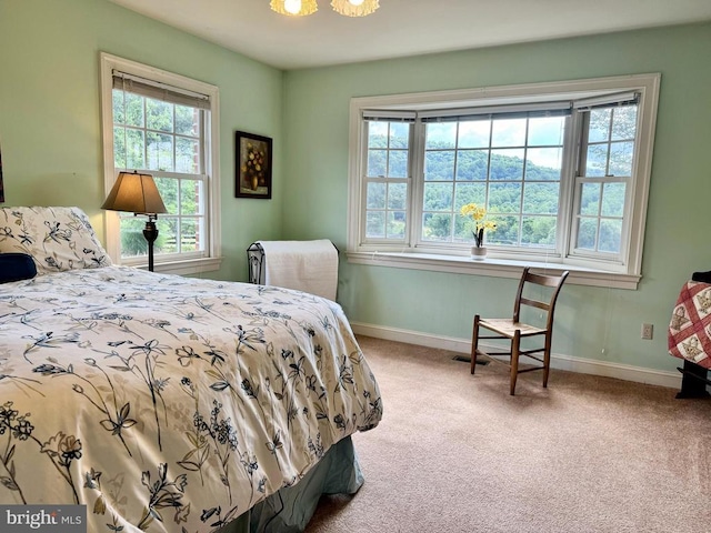 carpeted bedroom featuring baseboards