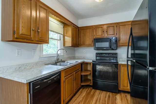 1014 Paul St, Harrisonburg, VA 22802 - kitchen with black appliances, a sink, and brown cabinetry