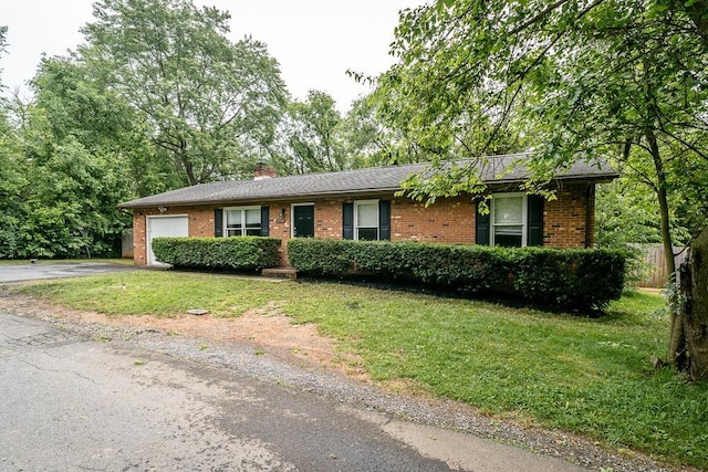 1014 Paul St, Harrisonburg, VA 22802 - single story home featuring brick siding, asphalt driveway, an attached garage, a front lawn, and a chimney