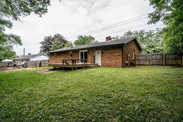 1014 Paul St, Harrisonburg, VA 22802 - rear view of property featuring a wooden deck, brick siding, and a chimney