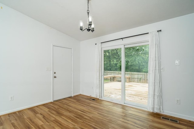 1014 Paul St, Harrisonburg, VA 22802 - unfurnished room with wood finished floors, a chandelier, lofted ceiling, and baseboards
