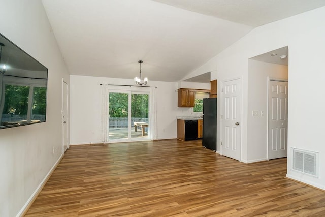 1014 Paul St, Harrisonburg, VA 22802 - unfurnished living room with a chandelier, lofted ceiling, light wood-style floors, and baseboards