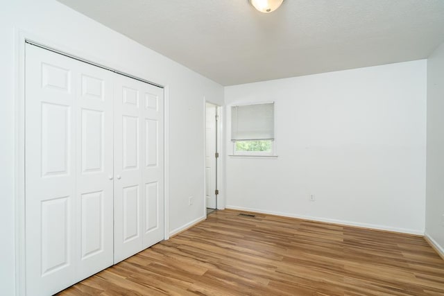 1014 Paul St, Harrisonburg, VA 22802 - unfurnished bedroom with light wood-style flooring, baseboards, and a closet