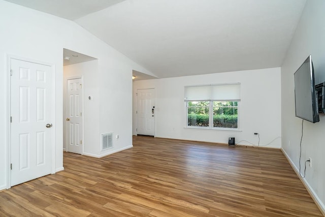 1014 Paul St, Harrisonburg, VA 22802 - unfurnished living room featuring light wood-style floors, vaulted ceiling, and baseboards