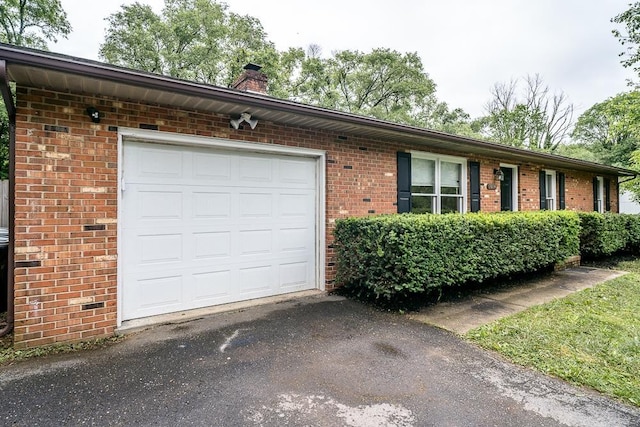 1014 Paul St, Harrisonburg, VA 22802 - view of front of property with brick siding, a chimney, an attached garage, and driveway