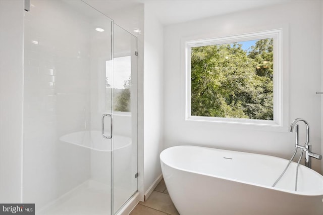 Kovi Ridge Trl, Reva, VA 22735 - bathroom featuring a soaking tub, a shower stall, tile patterned flooring, and baseboards