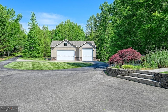 129 Lois Ln, Mineral, VA 23117 - view of front of home featuring an outdoor structure, driveway, an attached garage, a front yard, and stone siding