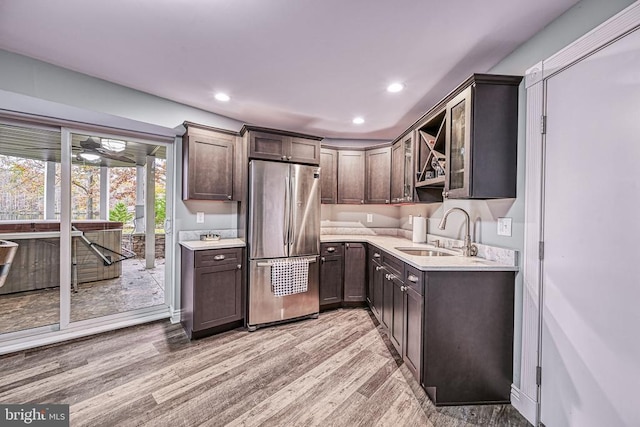 129 Lois Ln, Mineral, VA 23117 - kitchen featuring freestanding refrigerator, dark brown cabinets, a sink, light countertops, and light wood-type flooring