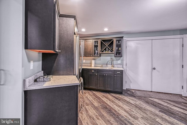 129 Lois Ln, Mineral, VA 23117 - kitchen featuring a sink, light countertops, light wood-type flooring, glass insert cabinets, and recessed lighting
