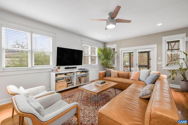 living area featuring ceiling fan, baseboards, french doors, and wood finished floors