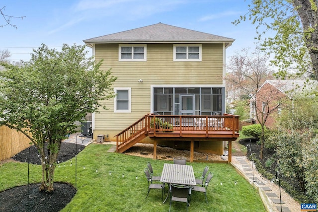 back of house with a deck, stairs, fence, a yard, and a sunroom