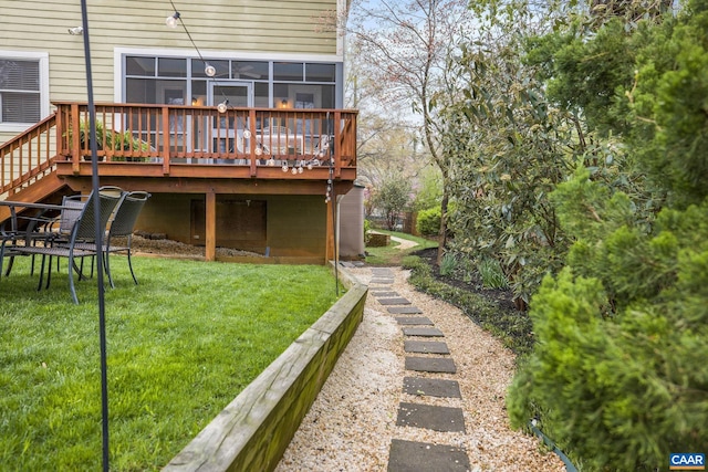 rear view of house with cooling unit, a yard, and a wooden deck