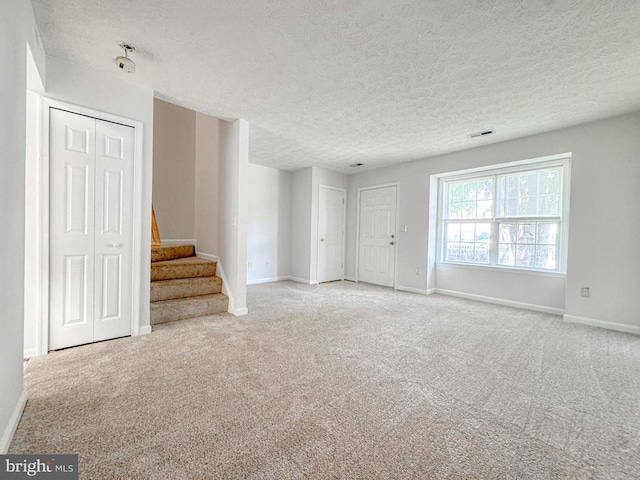 4110 Englandtown Rd, Fredericksburg, VA 22408 - unfurnished living room with a textured ceiling, carpet, and stairs
