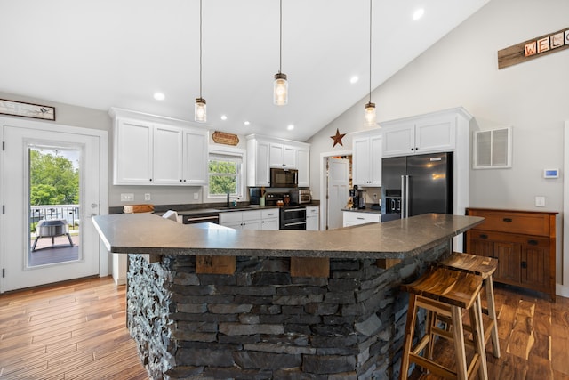 56 Serendipity Ln, Crimora, VA 24431 - kitchen featuring appliances with stainless steel finishes, dark countertops, a kitchen breakfast bar, white cabinetry, and recessed lighting