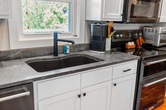 56 Serendipity Ln, Crimora, VA 24431 - kitchen with appliances with stainless steel finishes, white cabinetry, and dark countertops