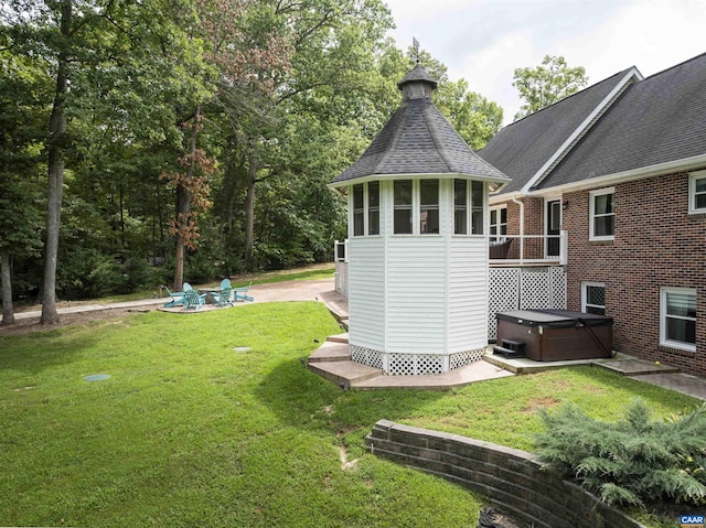 6406 Carter Ln, Mineral, VA 23117 - back of house featuring a hot tub, a lawn, a patio area, and roof with shingles