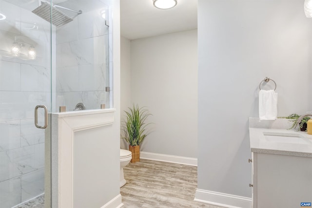 6406 Carter Ln, Mineral, VA 23117 - bathroom with baseboards, a shower stall, wood finished floors, toilet, and vanity