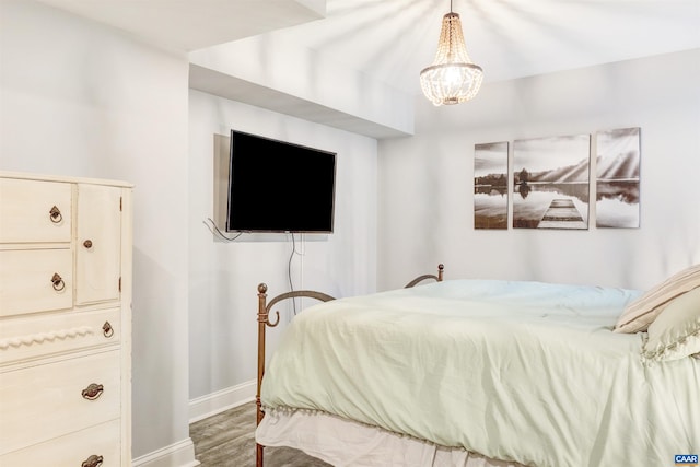 6406 Carter Ln, Mineral, VA 23117 - bedroom featuring baseboards, wood finished floors, and a chandelier