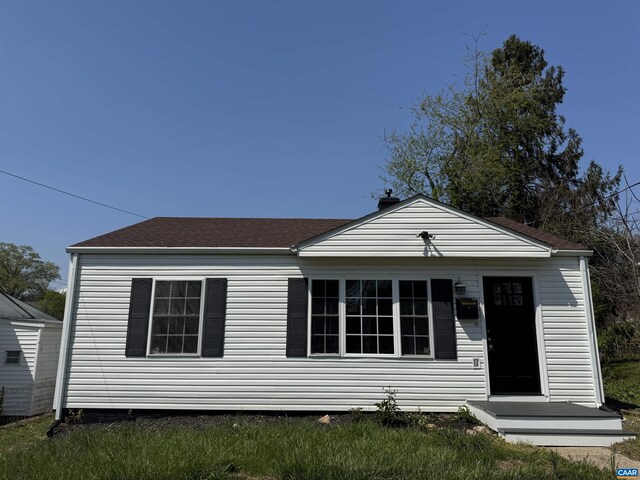 bungalow-style home with a shingled roof